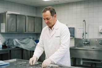 Thanatopracteur en blanc arrangeant ses outils